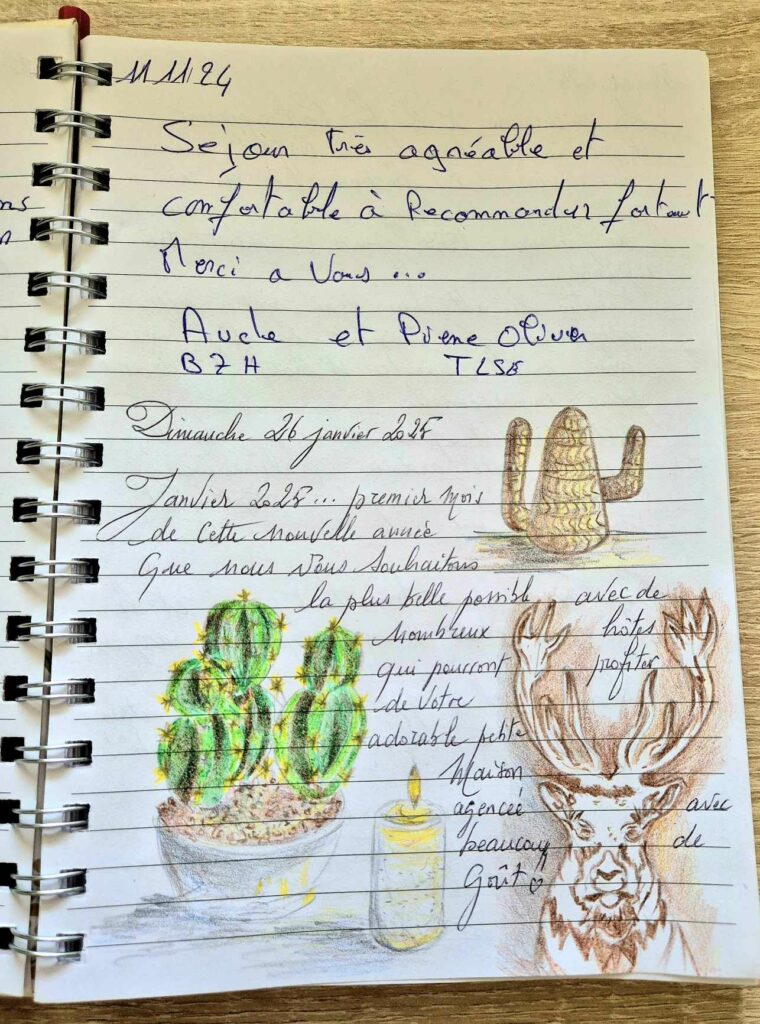 Page d'un livre d'or avec des remerciements écrits à la main et des dessins colorés de cactus et d'un cerf